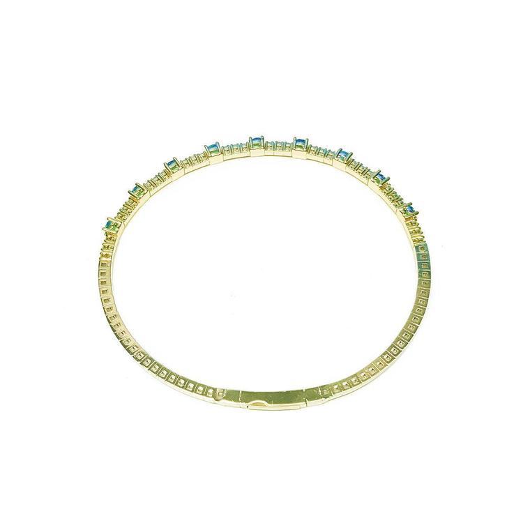 Flexible 14K yellow gold bangle bracelet with square-cut emeralds and accent diamonds.