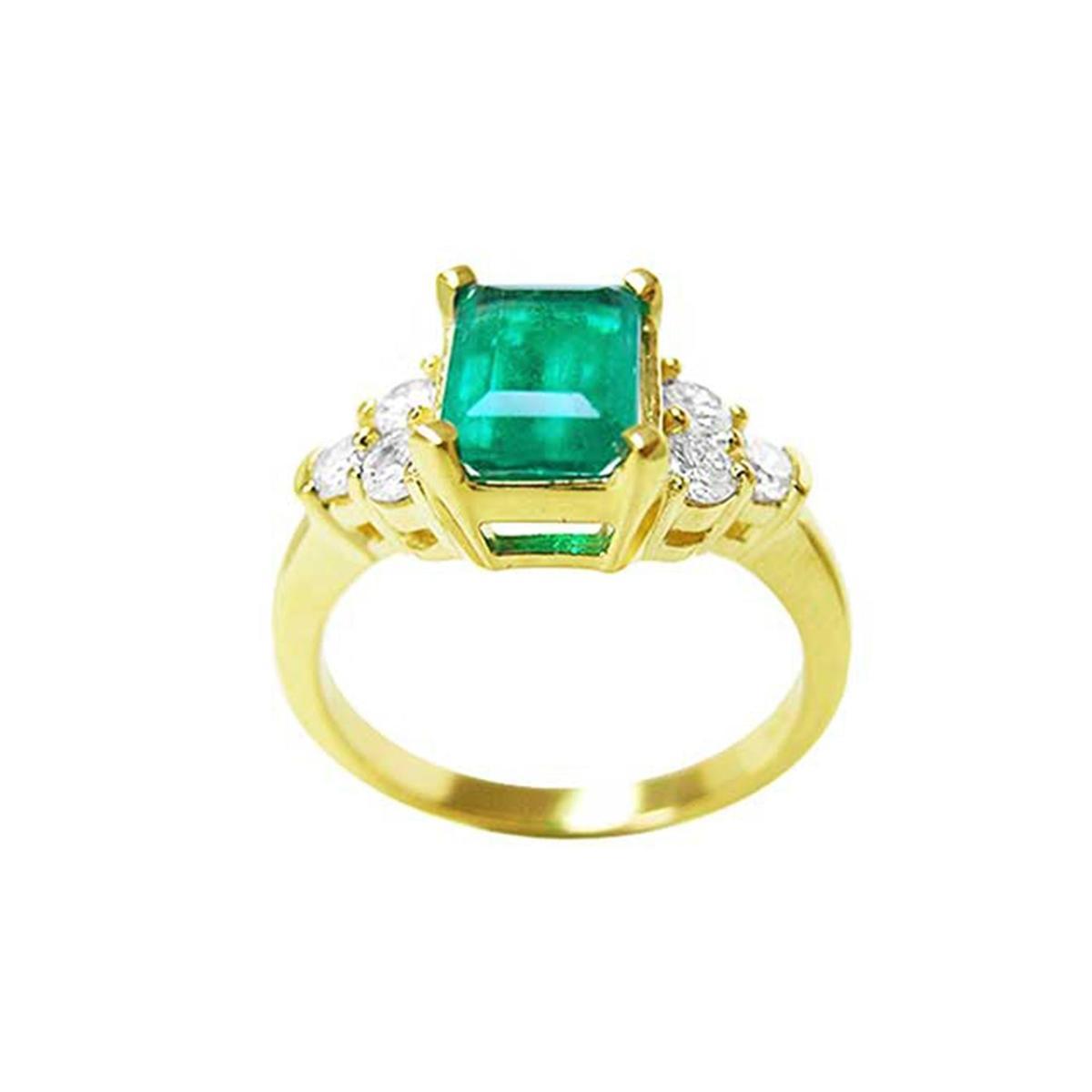 A yellow gold ring with a natural emerald and accent side diamonds, top and sides profile view.