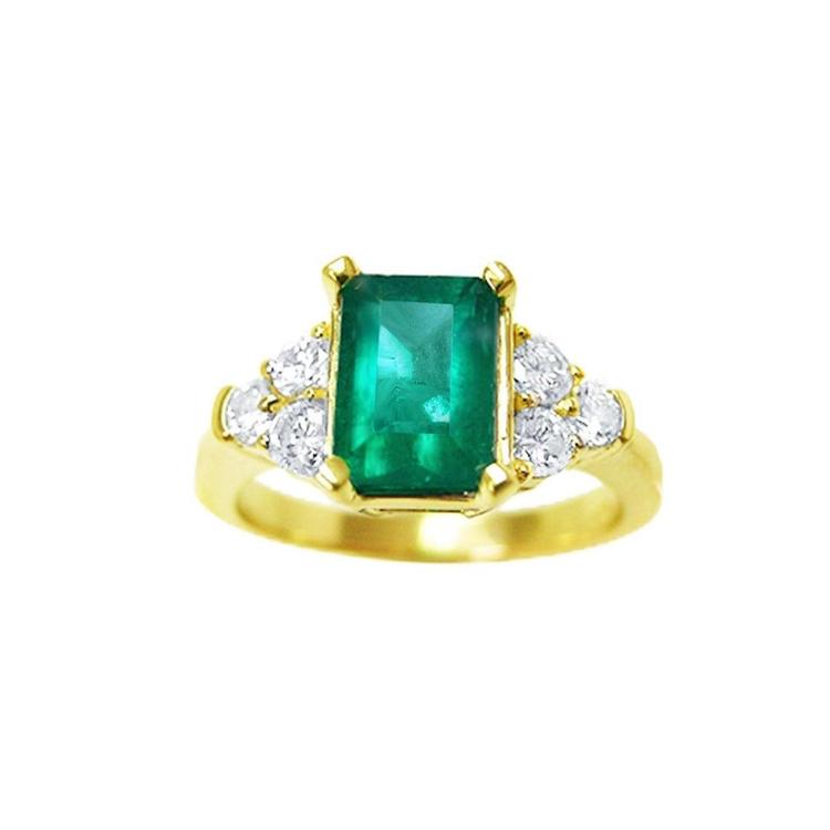 A women's emerald ring with accent side diamonds crafted in 14k yellow gold.