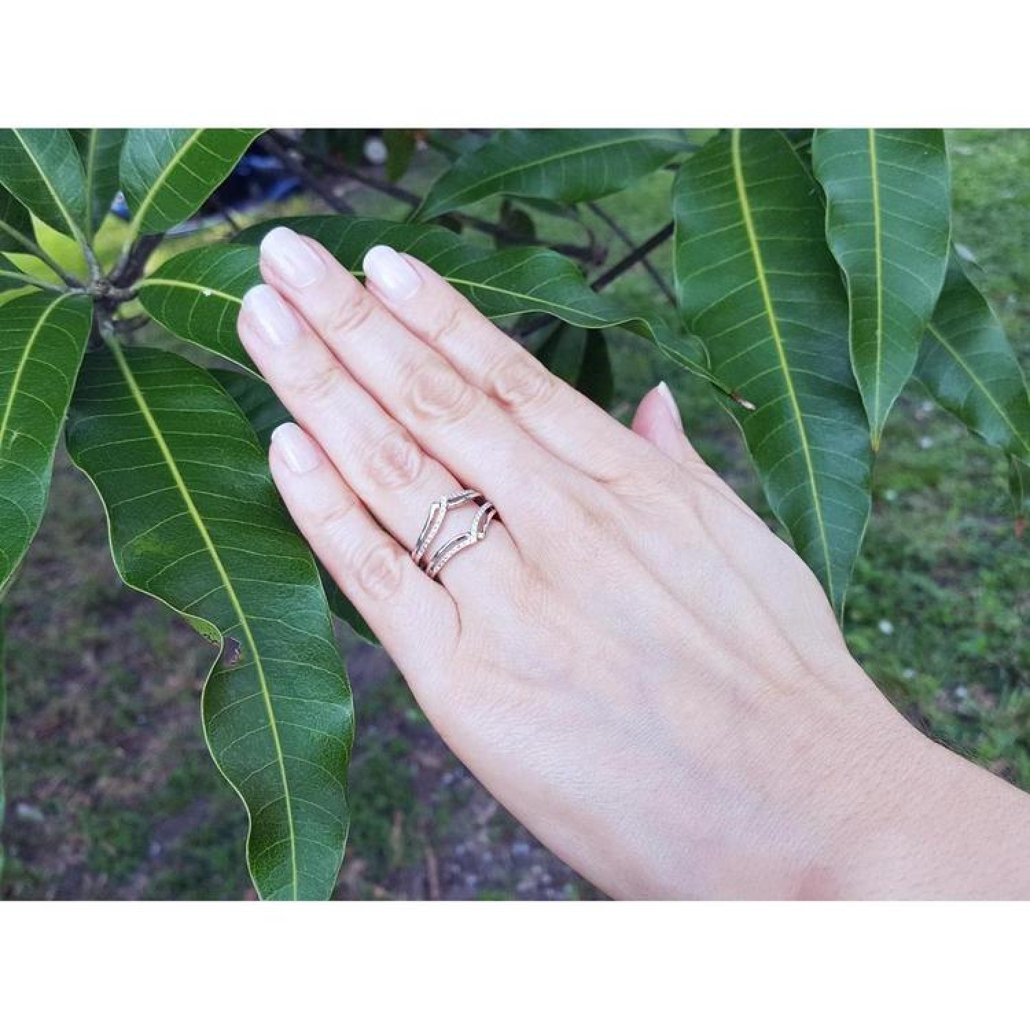 14K white gold diamond ring guard enhancer with double rows of natural diamonds, worn on a hand.