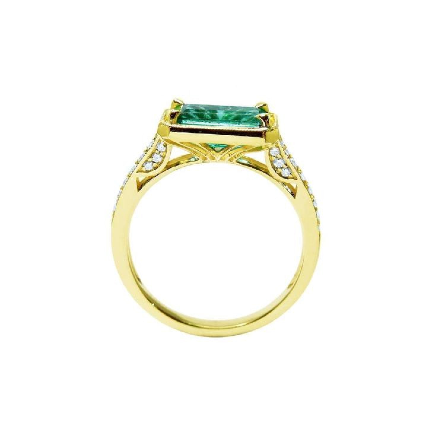 1.30 carat emerald-cut natural Colombian emerald ring in 14K yellow gold, east-west style with diamond accents.