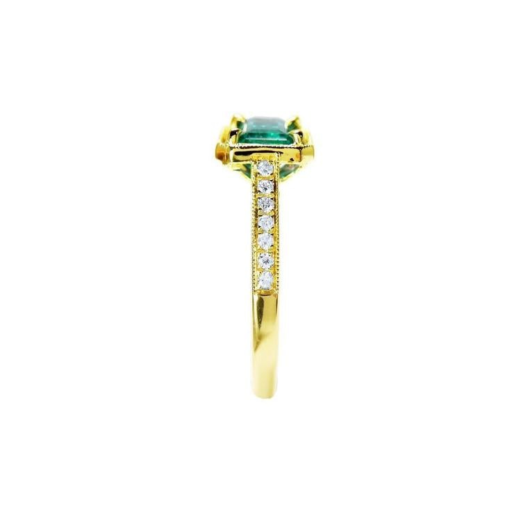 1.30 carat emerald-cut natural Colombian emerald ring in 14K yellow gold, east-west style with diamond accents.