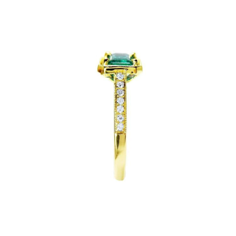 1.30 carat emerald-cut natural Colombian emerald ring in 14K yellow gold, east-west style with diamond accents.