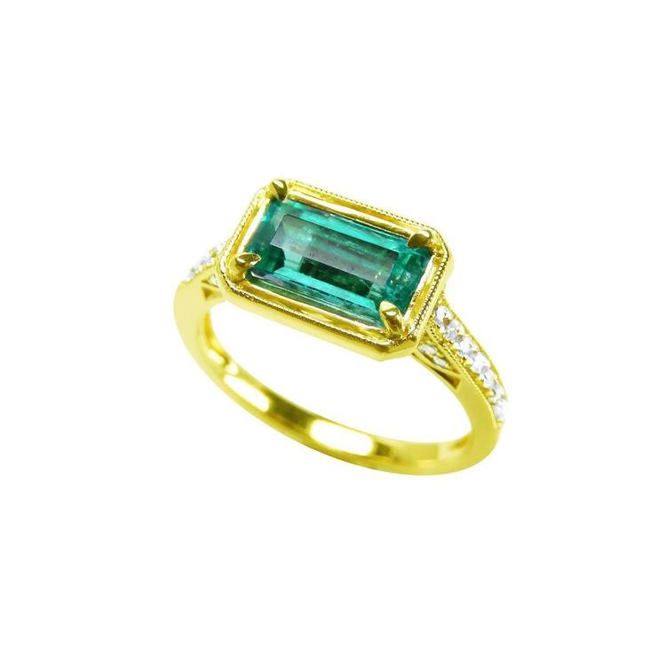 1.30 carat emerald-cut natural Colombian emerald ring in 14K yellow gold, east-west style with diamond accents.