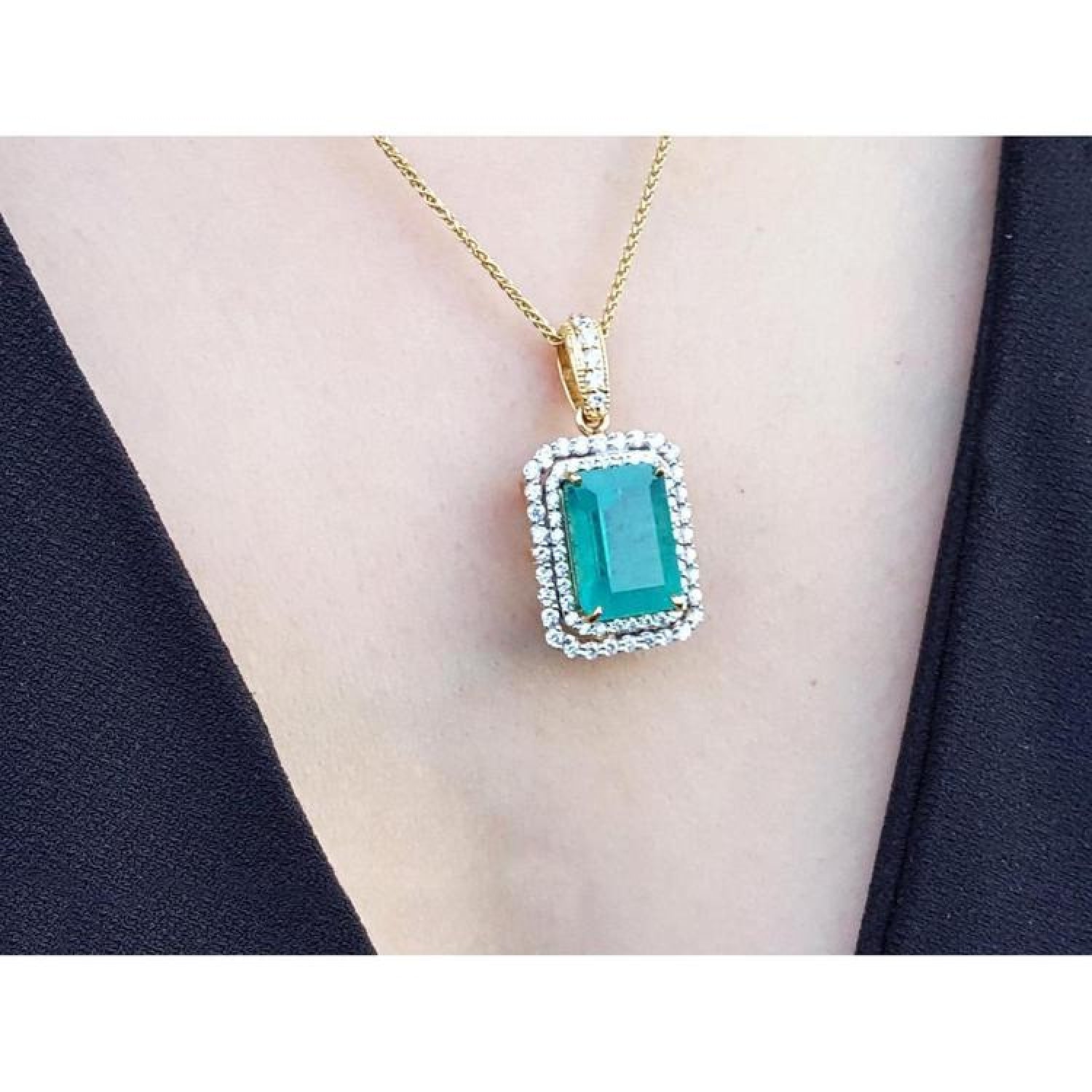 18K yellow gold emerald pendant with a rectangular emerald-cut stone and double halo natural diamonds.