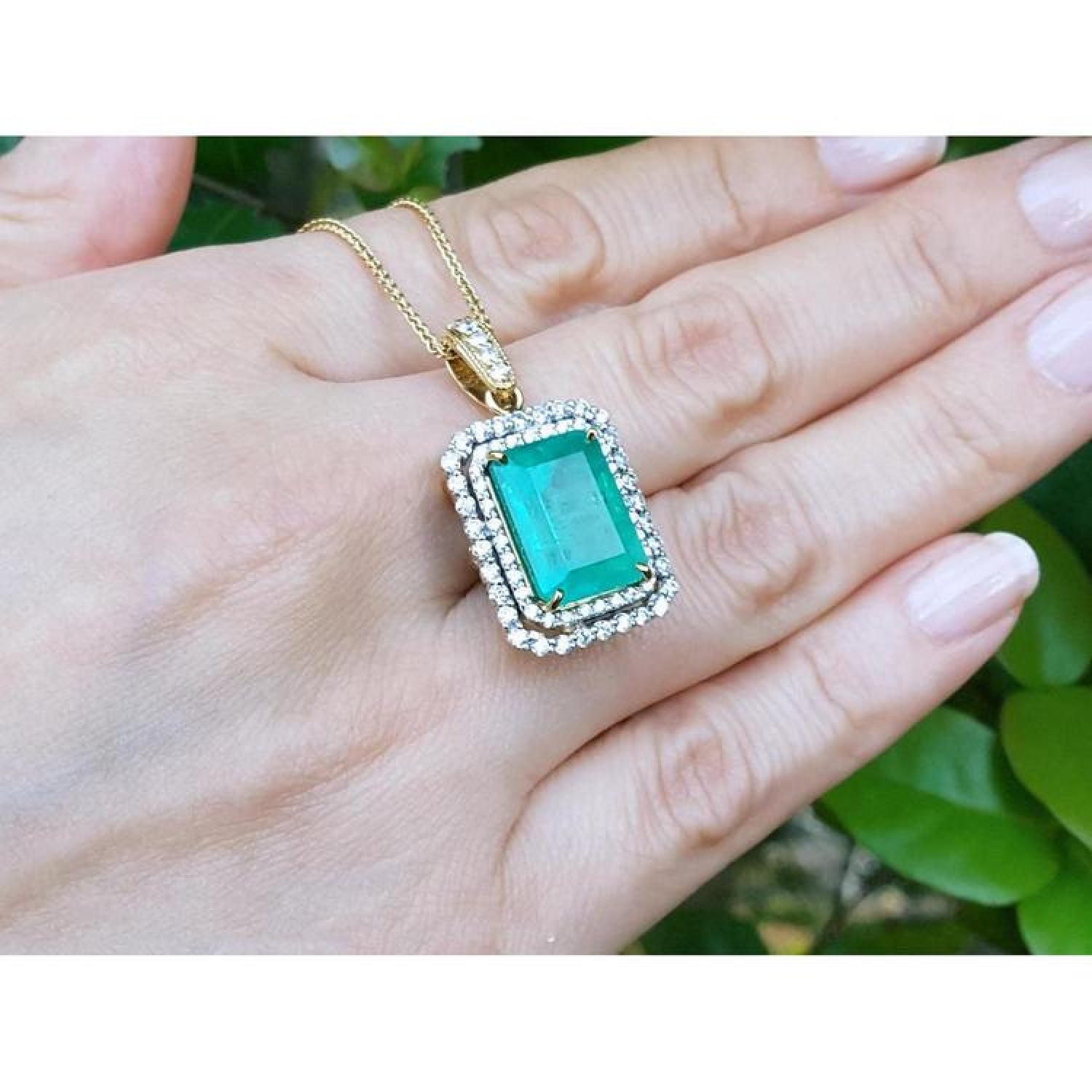 18K yellow gold emerald pendant with a rectangular emerald-cut stone and double halo natural diamonds.