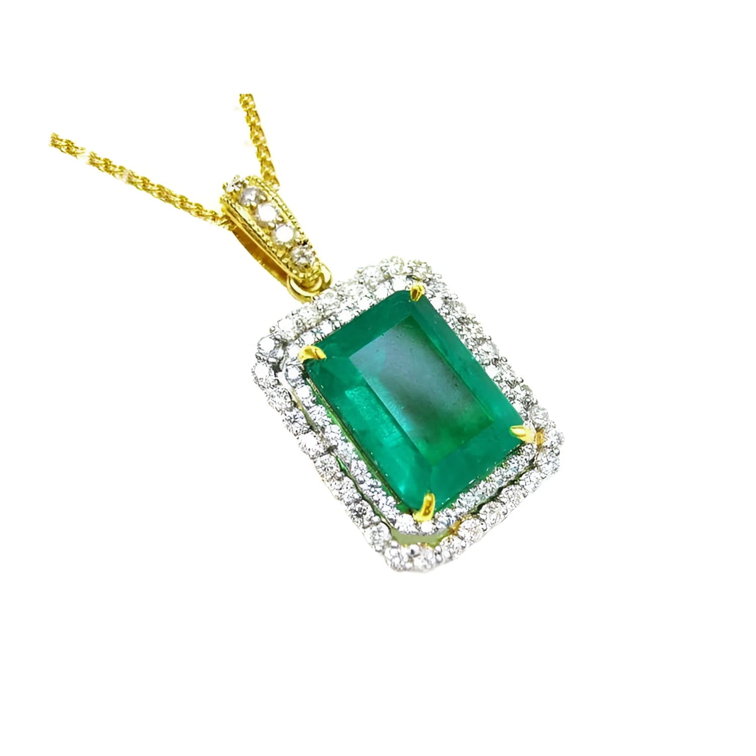 A yellow gold emerald pendant displaying the topside rectangular emerald surrounded by a double halo diamond.
