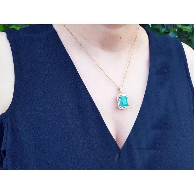 18K yellow gold emerald pendant with a rectangular emerald-cut stone and double halo natural diamonds.