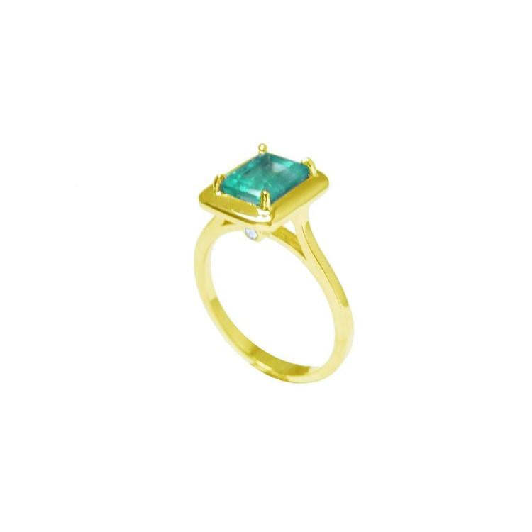 A 14k emerald solitaire ring on a half side position showing the top and side band ring profile.