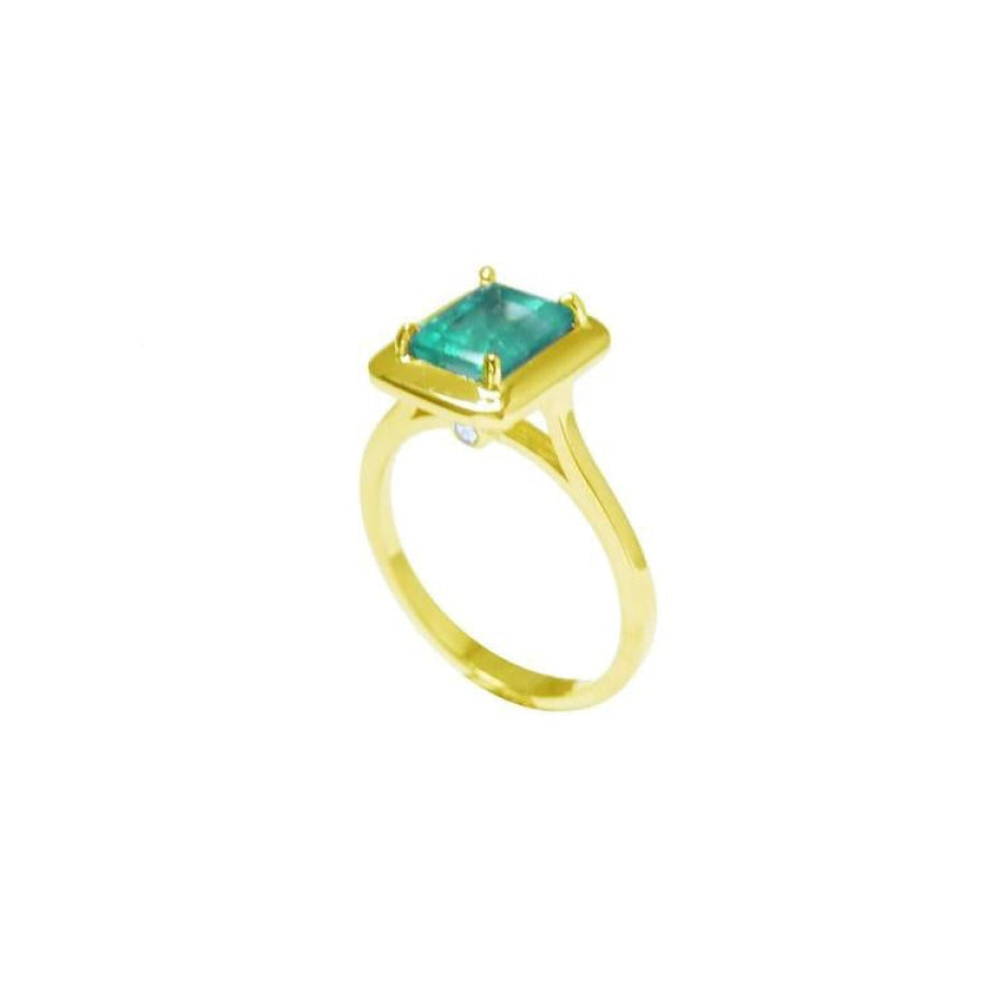 1.22 carat emerald-cut Muzo Colombian emerald solitaire ring in 14K yellow gold.