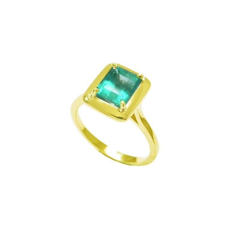 This emerald solitaire ring shows the top natural colombian emerald encased in wide bezels and shank profile.