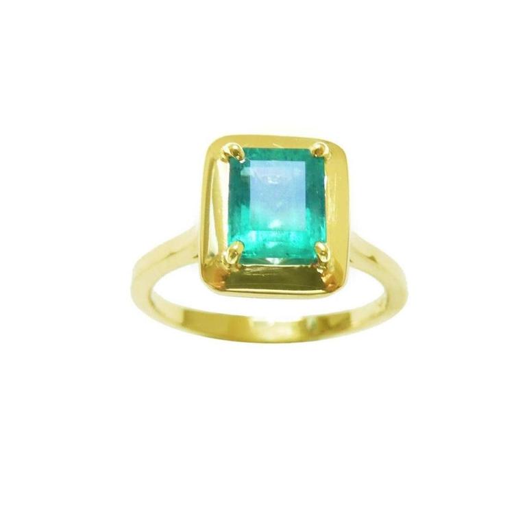 Solitaire natural emerald ring rectangular emerald-cut emerald and prong set in 14k yellow gold.