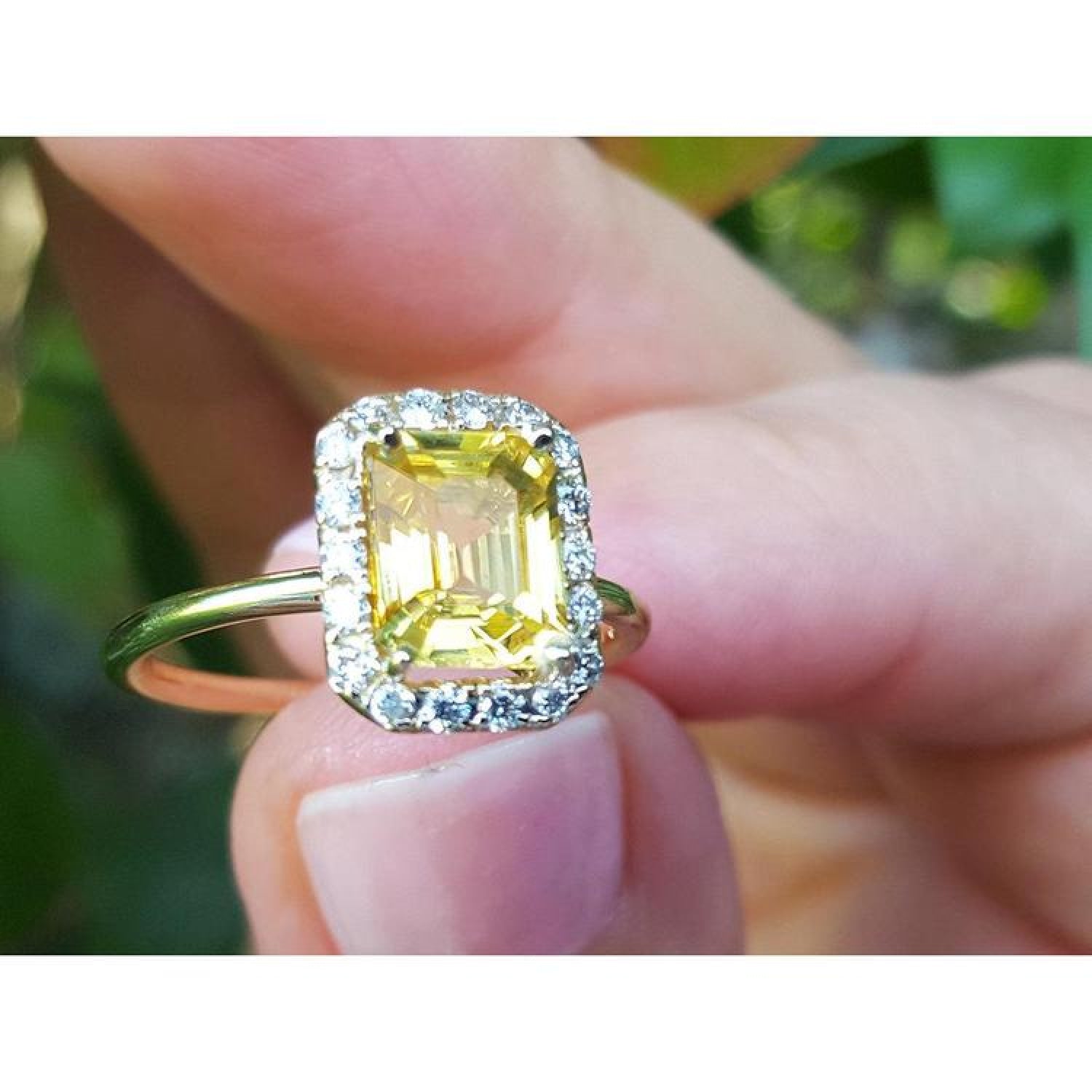 14K yellow gold ring with emerald-cut natural yellow sapphire and diamond halo.