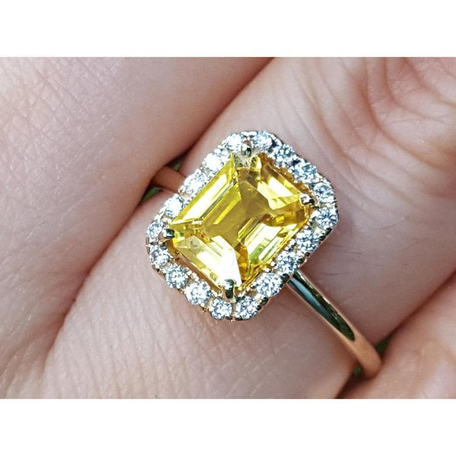 14K yellow gold ring with emerald-cut natural yellow sapphire and diamond halo.