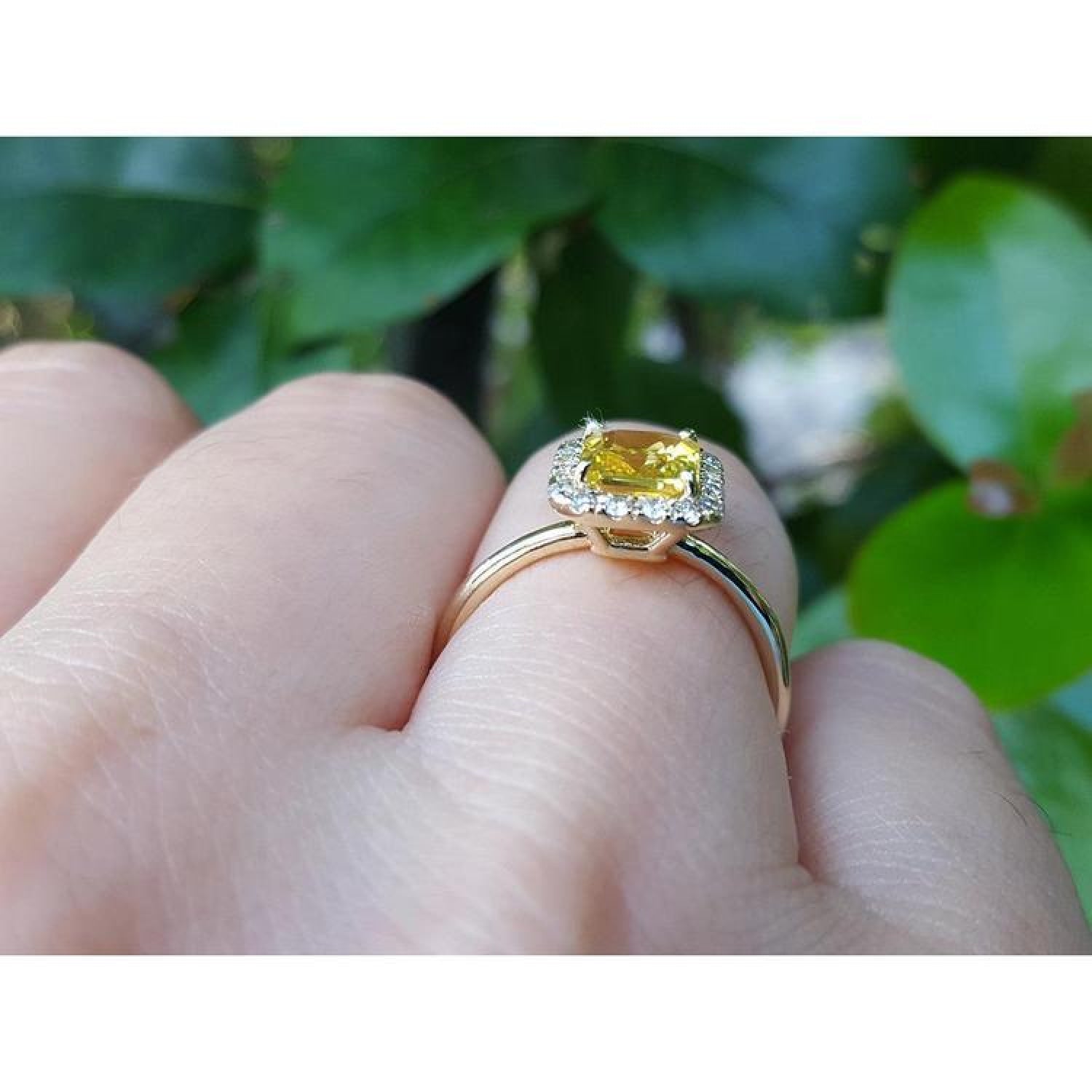 14K yellow gold ring with an emerald-cut natural yellow sapphire and diamond halo.