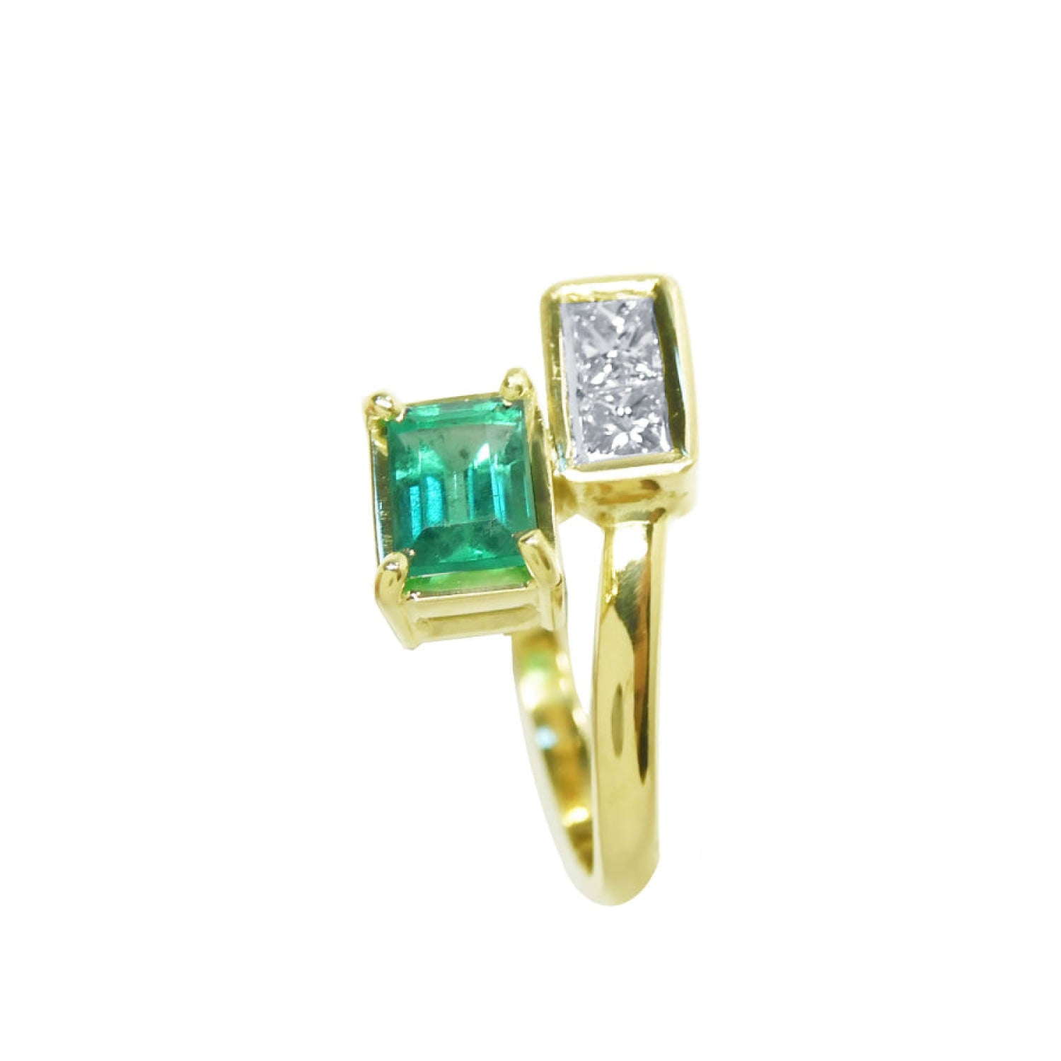 A 18k yellow gold toi et moi or you and me ring with a rectangular colombian emerald emerald-cut on one side and princess cut diamonds.